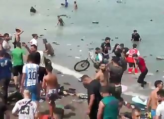 This migrant is swimming across while holding his bike above the water