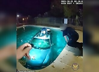  Police save a man who has just fallen into a swimming pool with his car 