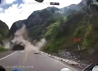 A boulder falls from a mountain and crushes a truck