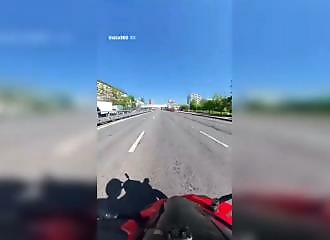 He narrowly avoids the SUV, gets off his motorcycle, and kicks the side mirror