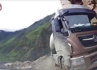 A truck swept away by a landslide on a road in Tibet