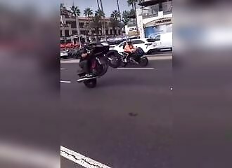 A motorcyclist speeds through town while doing a backwards cartwheel, which turns out badly for him (Warning - shocking)