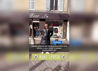 She tries to set fire to a bank (France) and poses in front of the establishment