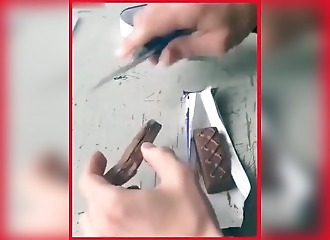 A Russian officer films the inside of a Mars bar that is believed to contain an explosive device