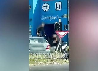 Road rage: He climbs on top of the car to kick out the windscreen!