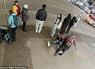 A man takes a punch for no reason in the street in Vancouver 