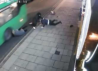Woman attacked narrowly misses being run over by a bus