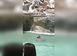 This tourist is swimming in Rome's most famous fountain