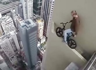 This guy rides his bike on top of a tower