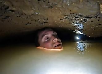 A caver misses his air bubble and finds himself submerged in water