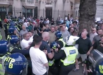 British policeman punches protester several times