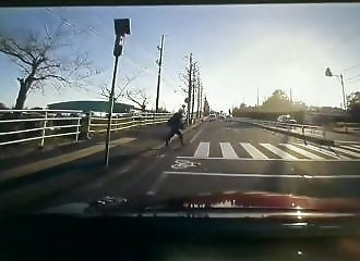 Pedestrian grazed by a car while crossing a crosswalk