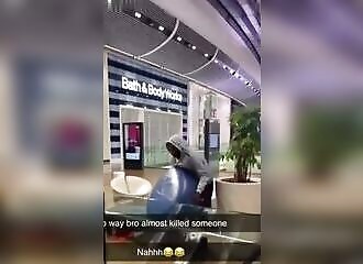 A man throws a chair from the second floor of a London shopping mall