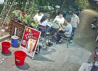 An air conditioner falls from the sky in the middle of a card game in China