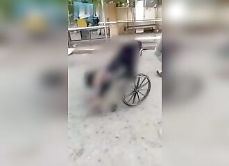 A man pushes the corpse of his 100-year-old wheelchair-bound mother down the street