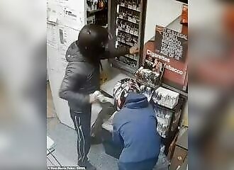 Two men break a store window with their motorcycle to steal alcohol and tobacco
