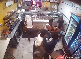 A gang violently attacks two customers in a chicken restaurant