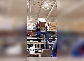 This store clerk is crushed by a cardboard box too heavy for him